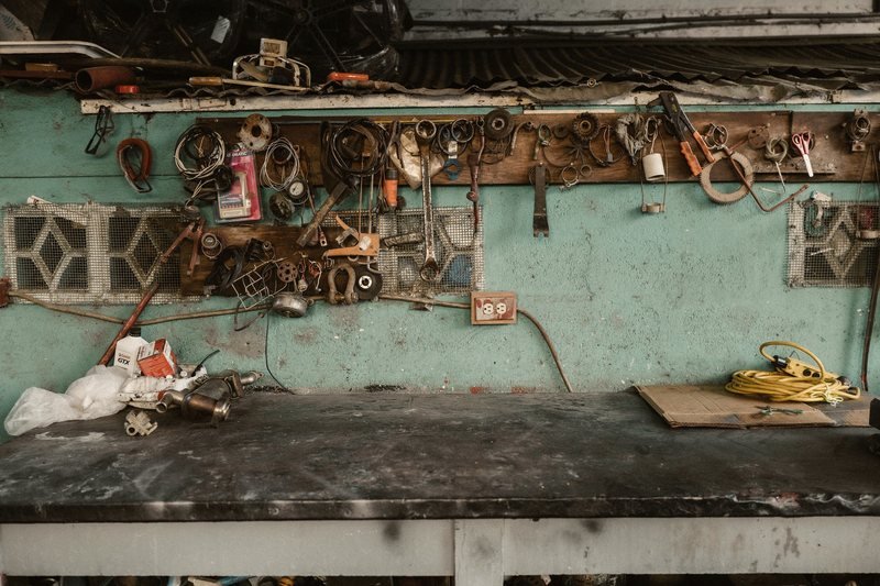Workbench with hand tools on a wall rack in a service shop